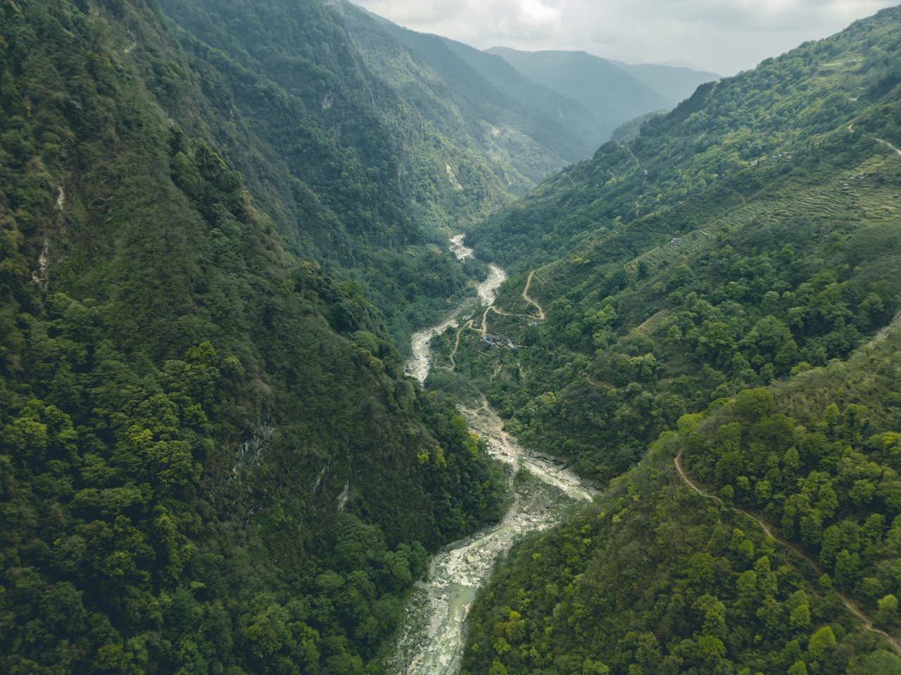 A river runs through a green valley